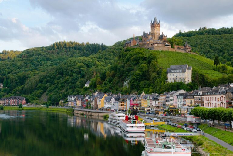 Castle on Hill over Village Near Body of Water