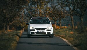 Volkswagen Driving on Countryside Road in Autumn