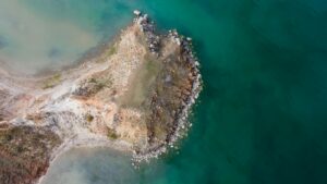 Captivating aerial shot of a rocky peninsula surrounded by the turquoise sea in Russia.